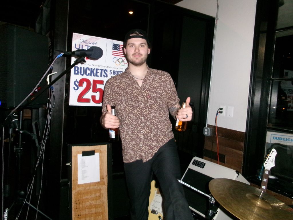 Chris holding two beers