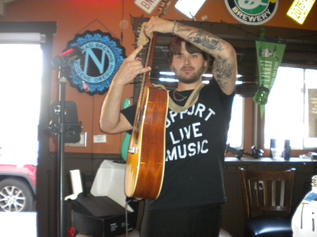 Chris raising his guitar overhead